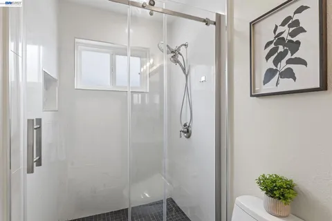 a bathroom with a shower and a sink