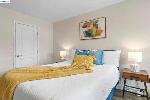 a bedroom with a bed a lamp and a window