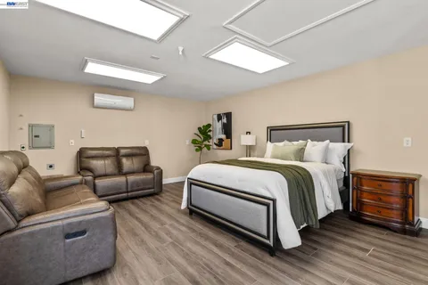 a bedroom with a bed and wooden floor