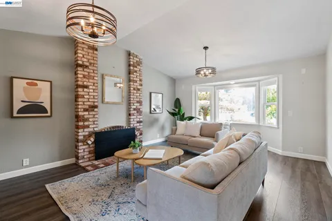 a living room with furniture a rug and a window