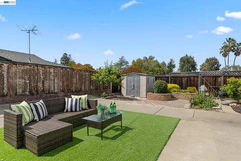 a front view of a house with a garden and patio