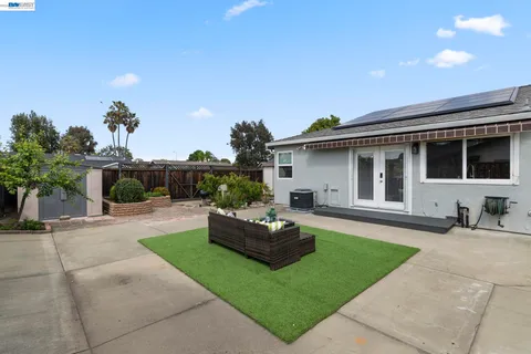 a front view of a house with garden and sitting area