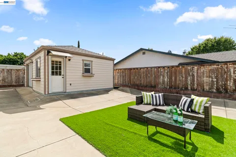 a front view of house with a garden and patio