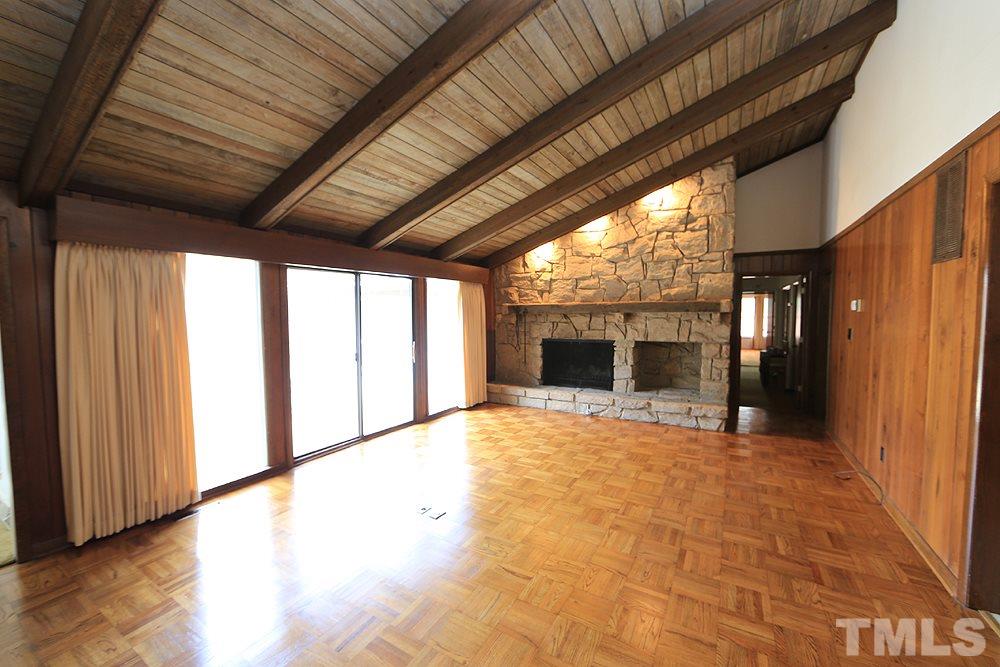 2700 Conover Court Raleigh, NC 27612 - Photo 11 of 30 a view of an empty room with a fireplace and a window