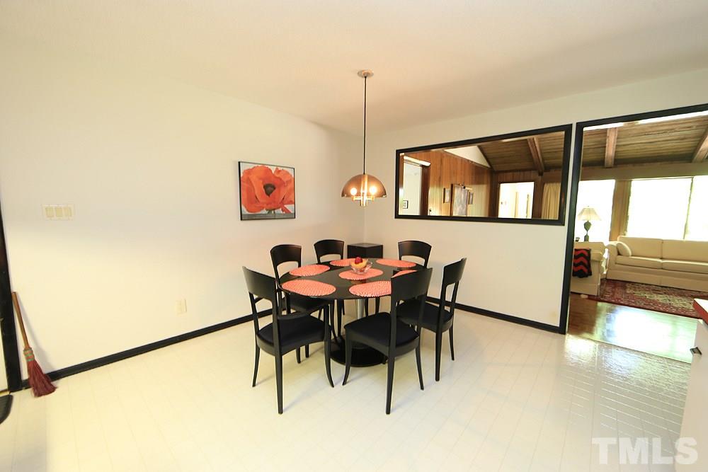 2700 Conover Court Raleigh, NC 27612 - Photo 17 of 30 a view of a dining room with furniture and a floor to ceiling window