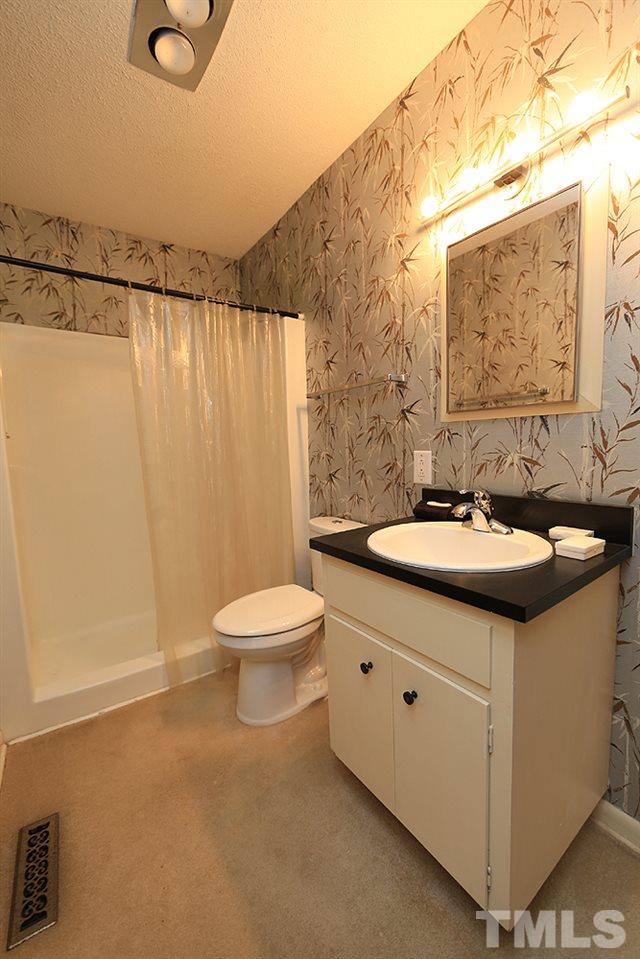 2700 Conover Court Raleigh, NC 27612 - Photo 20 of 30 a bathroom with a sink a toilet and shower