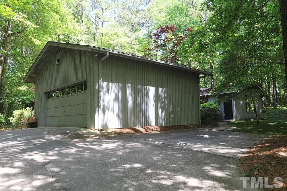 2700 Conover Court Raleigh, NC 27612 - Photo 3 of 30 a backyard of a house with large trees and a barn