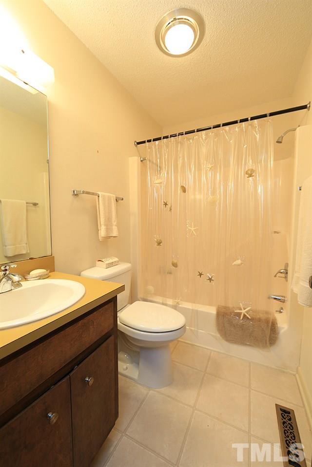 2700 Conover Court Raleigh, NC 27612 - Photo 22 of 30 a bathroom with a granite countertop sink toilet and shower