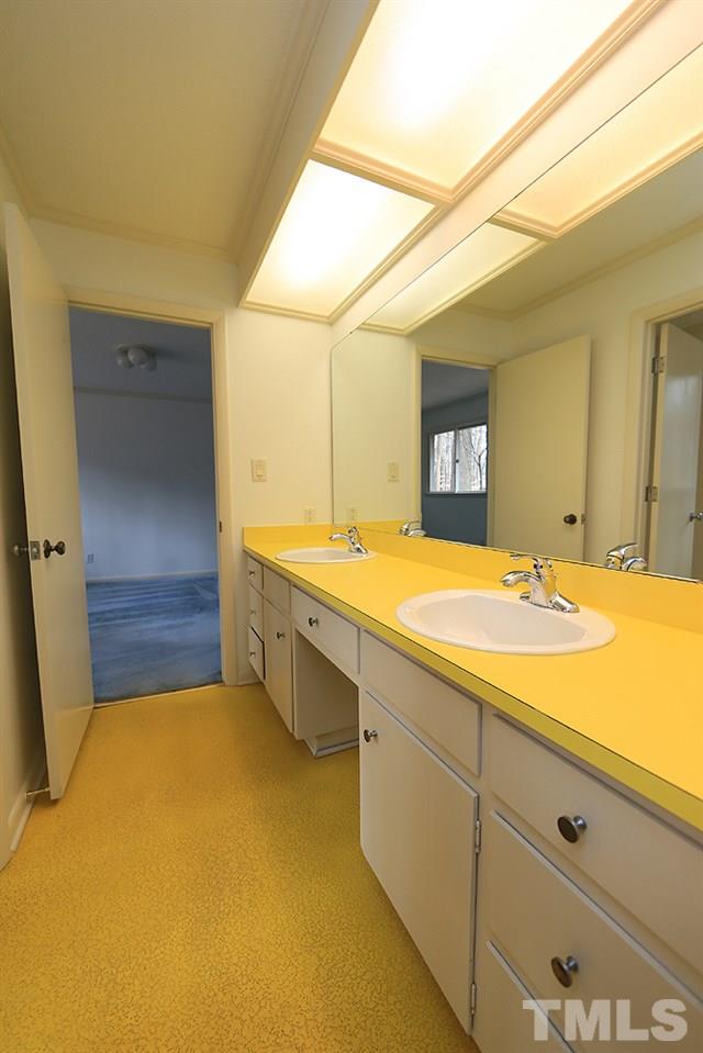 2700 Conover Court Raleigh, NC 27612 - Photo 24 of 30 a bathroom with a sink a large mirror and a bathtub