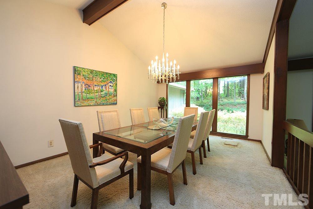2700 Conover Court Raleigh, NC 27612 - Photo 8 of 30 a view of a dining room with furniture a chandelier and wooden floor