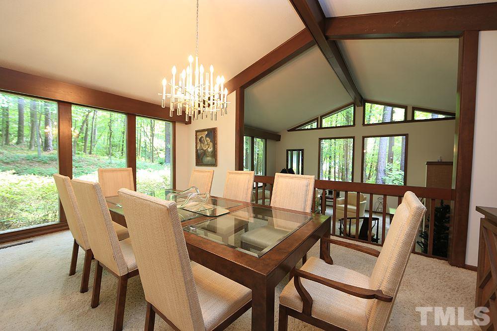 2700 Conover Court Raleigh, NC 27612 - Photo 9 of 30 a view of a dining room with furniture large windows and wooden floor