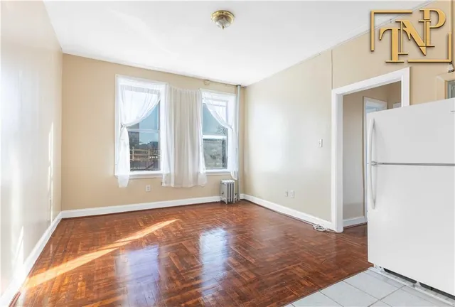 a view of a refrigerator in kitchen and a sink