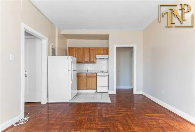 a kitchen with a refrigerator a stove top oven