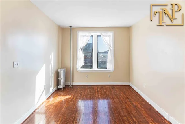 a view of a room with wooden floor