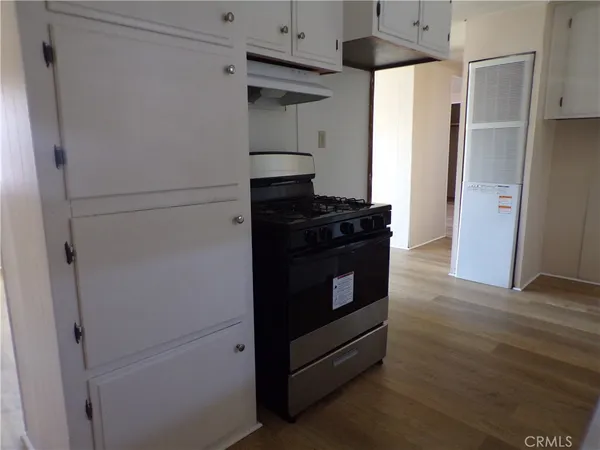 a kitchen with stainless steel appliances a refrigerator and a stove