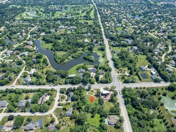 an aerial view of residential houses with outdoor space and street view