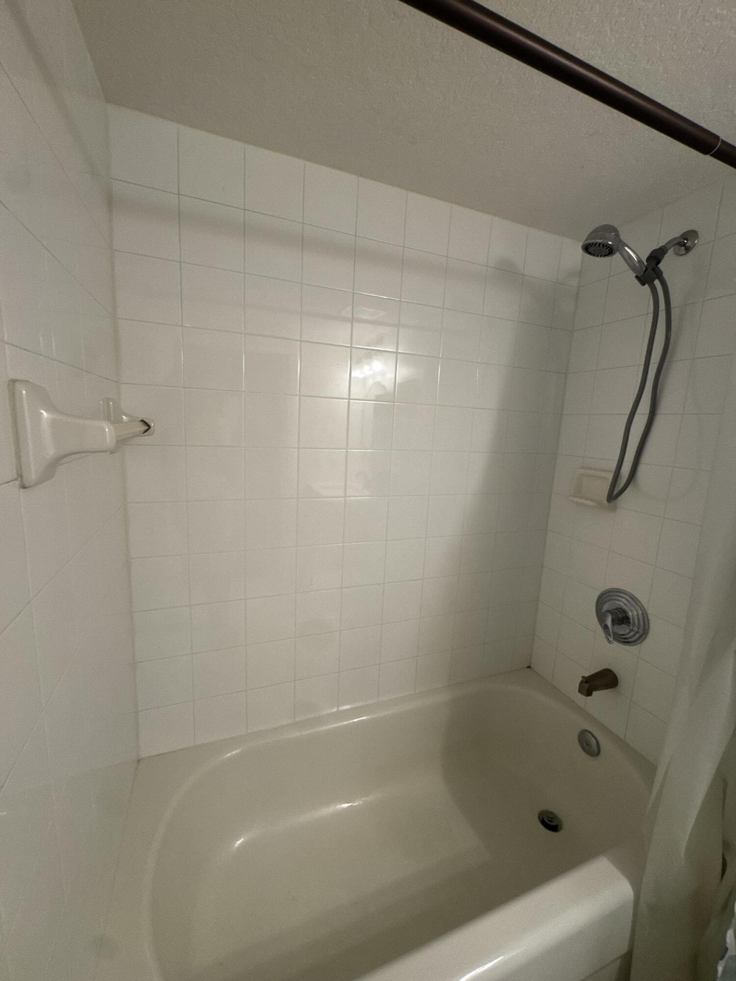 3810 North Jog Road, Unit 105 Royal Palm Beach, FL 33411 - Photo 15 of 26 a bath tub sitting next to a shower