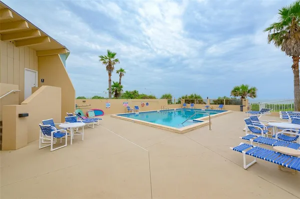 a view of a swimming pool with a lounge chair
