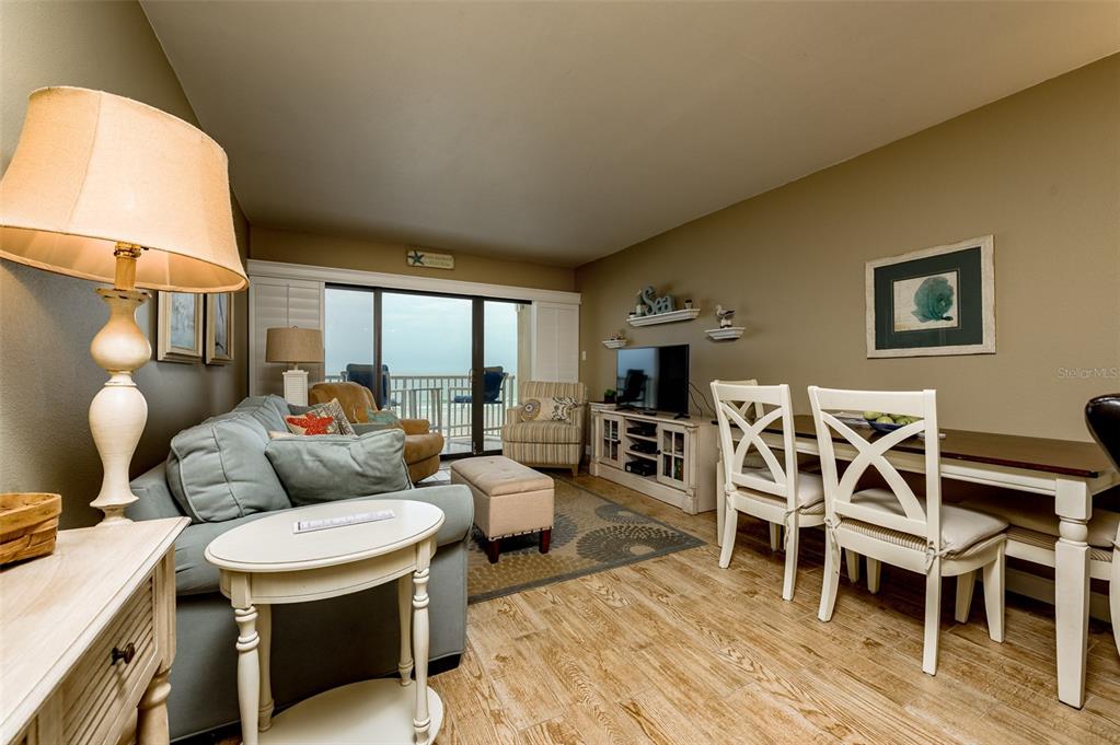 4799 South Atlantic Avenue, Unit 3030 Ponce Inlet, FL 32127 - Photo 5 of 26 a living room with furniture a rug and a floor to ceiling window