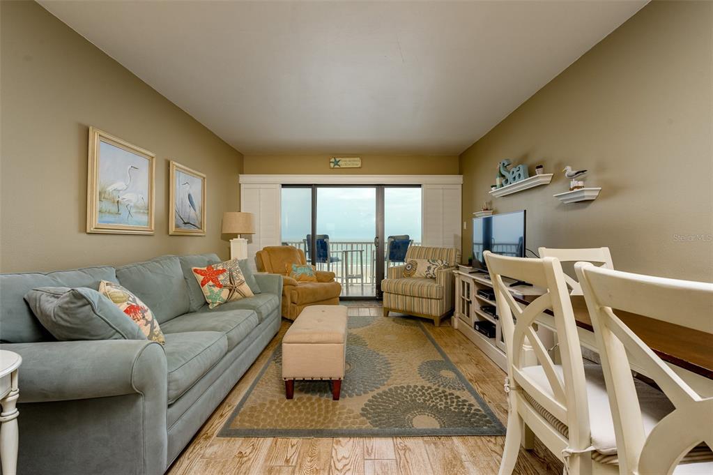 4799 South Atlantic Avenue, Unit 3030 Ponce Inlet, FL 32127 - Photo 6 of 26 a living room with furniture and a large window
