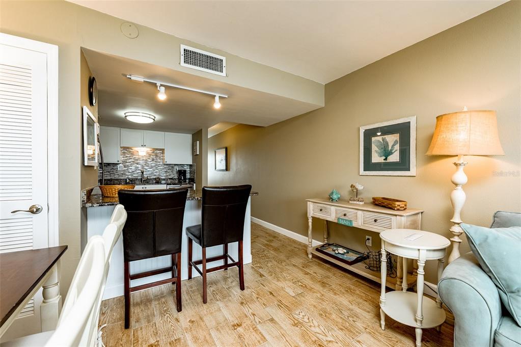 4799 South Atlantic Avenue, Unit 3030 Ponce Inlet, FL 32127 - Photo 9 of 26 a view of a dining room with furniture and wooden floor
