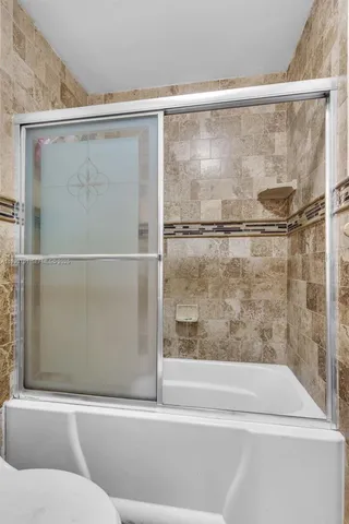 a bathroom with a shower and a bathtub