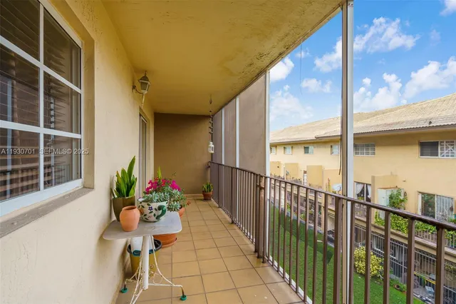 a view of a balcony with chair and wooden floor