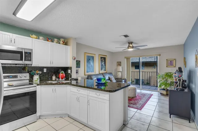 a kitchen with sink refrigerator and microwave