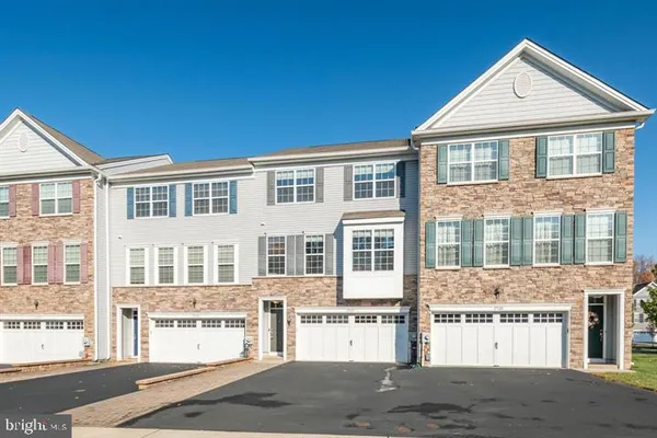 a front view of a residential apartment building with a yard