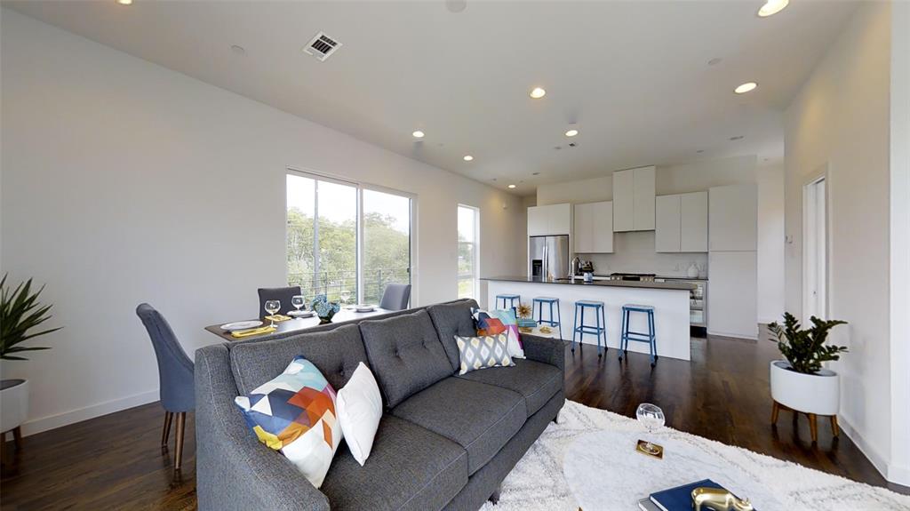 4905 Live Oak Street, Unit D Dallas, TX 75206 - Photo 1 of 19 a living room with furniture and a large window