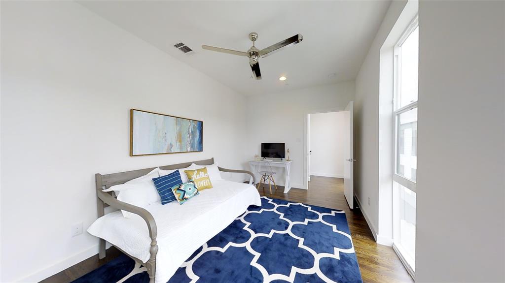 4905 Live Oak Street, Unit D Dallas, TX 75206 - Photo 13 of 19 a bedroom with a bed and wooden floor