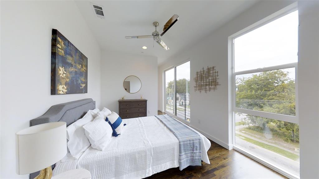 4905 Live Oak Street, Unit D Dallas, TX 75206 - Photo 15 of 19 a bedroom with a large bed and a large window