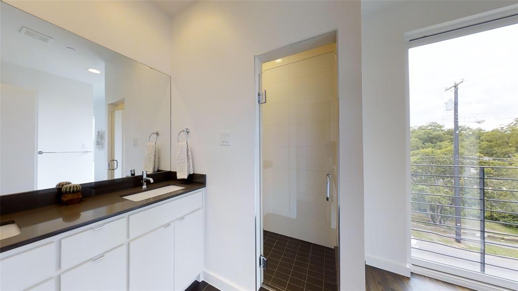 4905 Live Oak Street, Unit D Dallas, TX 75206 - Photo 18 of 19 a bathroom with a sink and a mirror