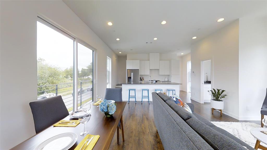 4905 Live Oak Street, Unit D Dallas, TX 75206 - Photo 2 of 19 a living room filled with furniture and a large window