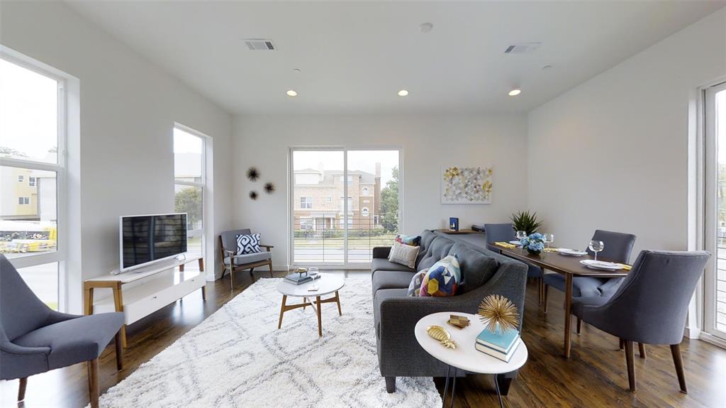 4905 Live Oak Street, Unit D Dallas, TX 75206 - Photo 5 of 19 a living room with furniture a flat screen tv and a large window