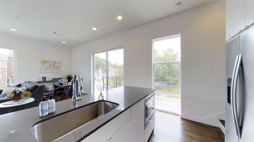 4905 Live Oak Street, Unit D Dallas, TX 75206 - Photo 10 of 19 a view of kitchen island with furniture and wooden floor
