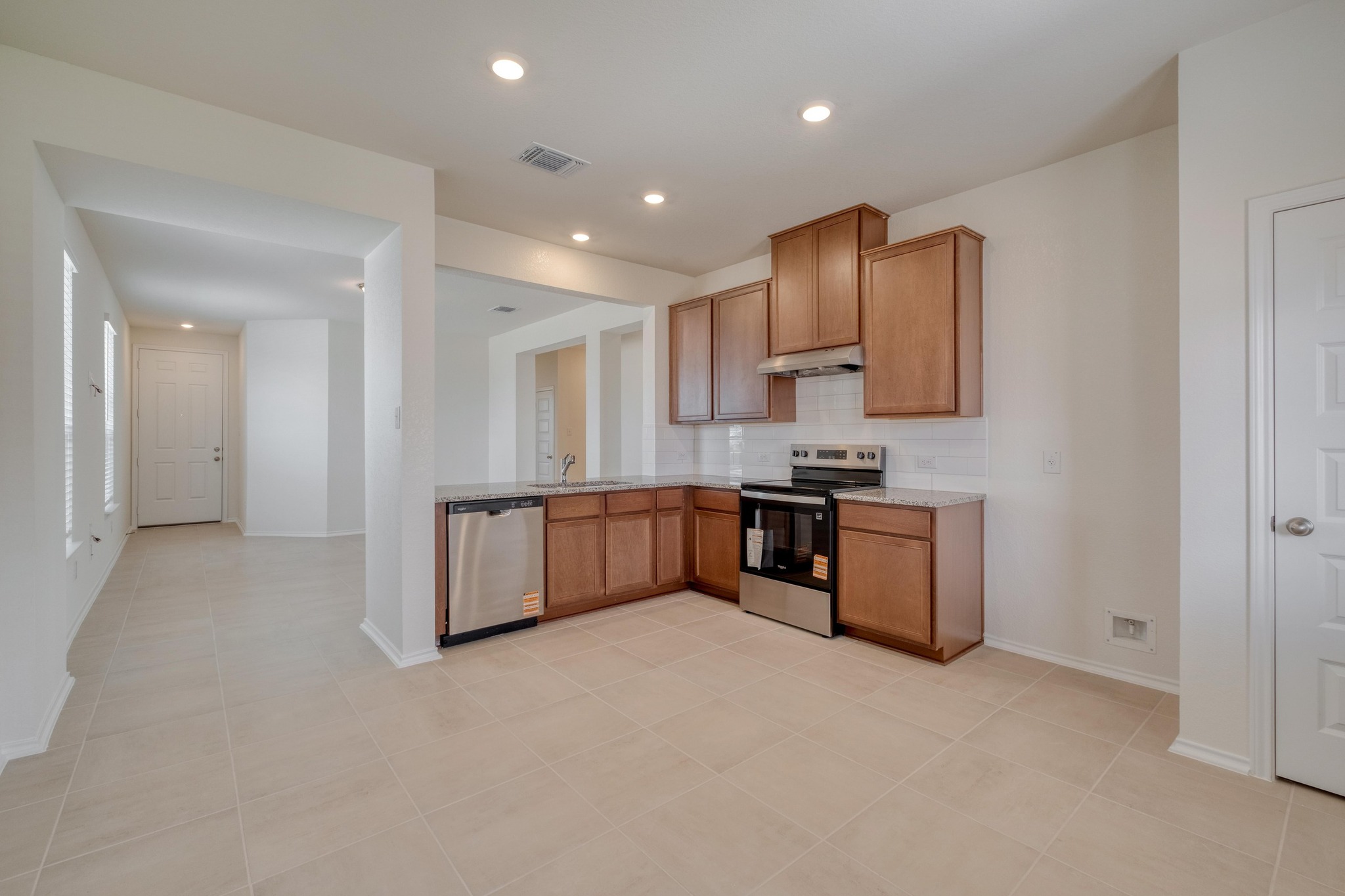 280 Feathers Street Jarrell, TX 76537 - Photo 14 of 28 a kitchen with stainless steel appliances granite countertop a stove a sink a refrigerator and a refrigerator