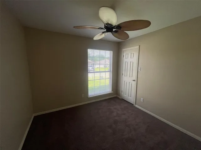 a view of a livingroom with a ceiling fan and window
