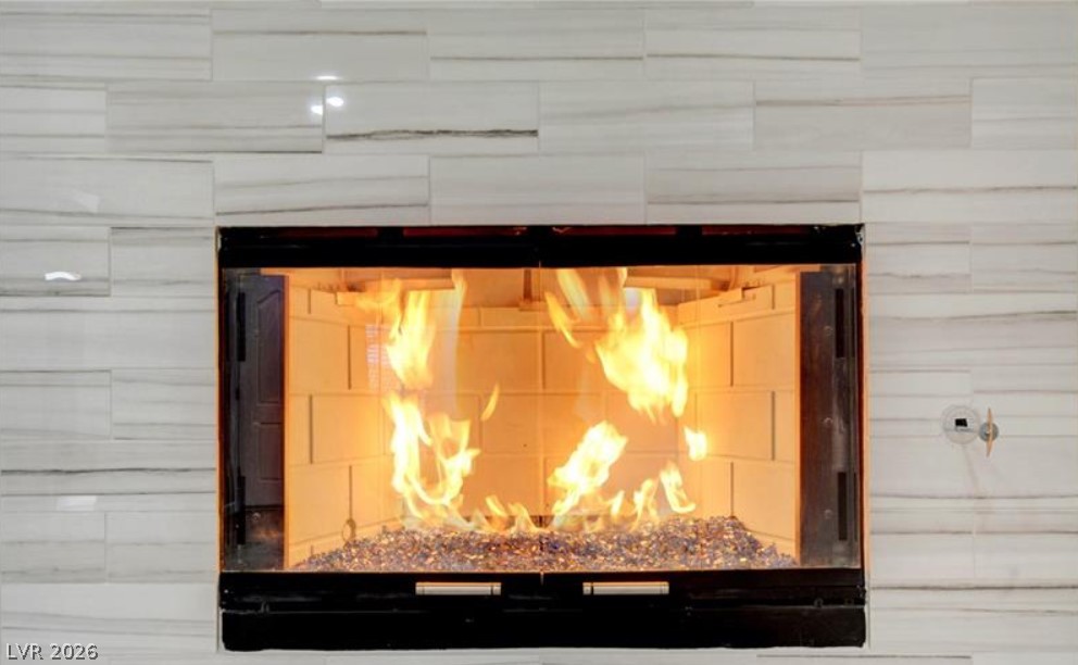 2716 Showcase Drive Las Vegas, NV 89134 - Photo 6 of 45 A modern fireplace with a tiled surround radiates warmth and ambiance.