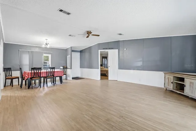 a view of room with window and ceiling fan