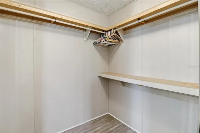 an aerial view of residential houses with outdoor space and trees all around