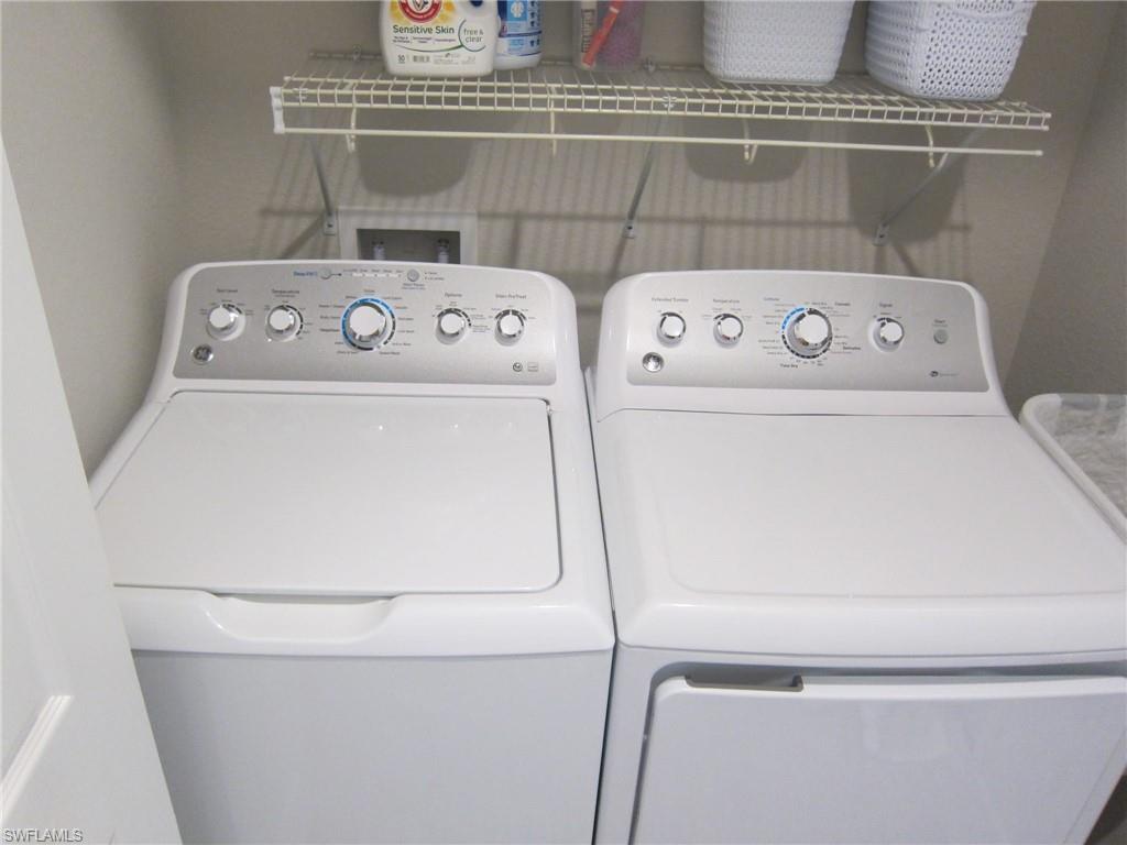 1170 Genovesa Court, Unit 12 Naples, FL 34113 - Photo 14 of 18 a utility room with dryer and washer