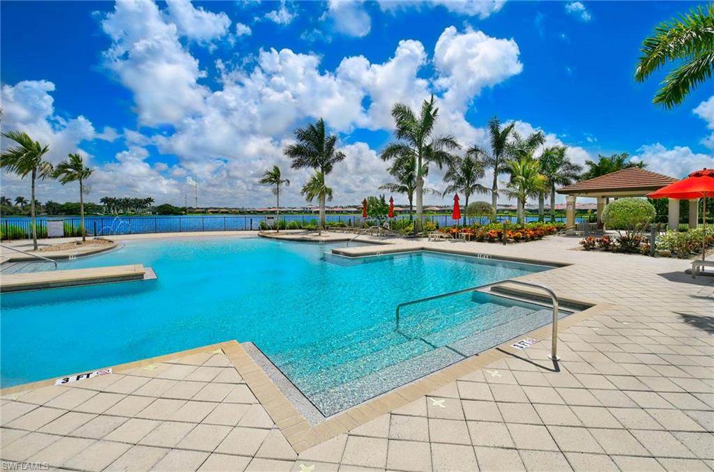 1170 Genovesa Court, Unit 12 Naples, FL 34113 - Photo 17 of 18 a view of swimming pool with outdoor seating and plants