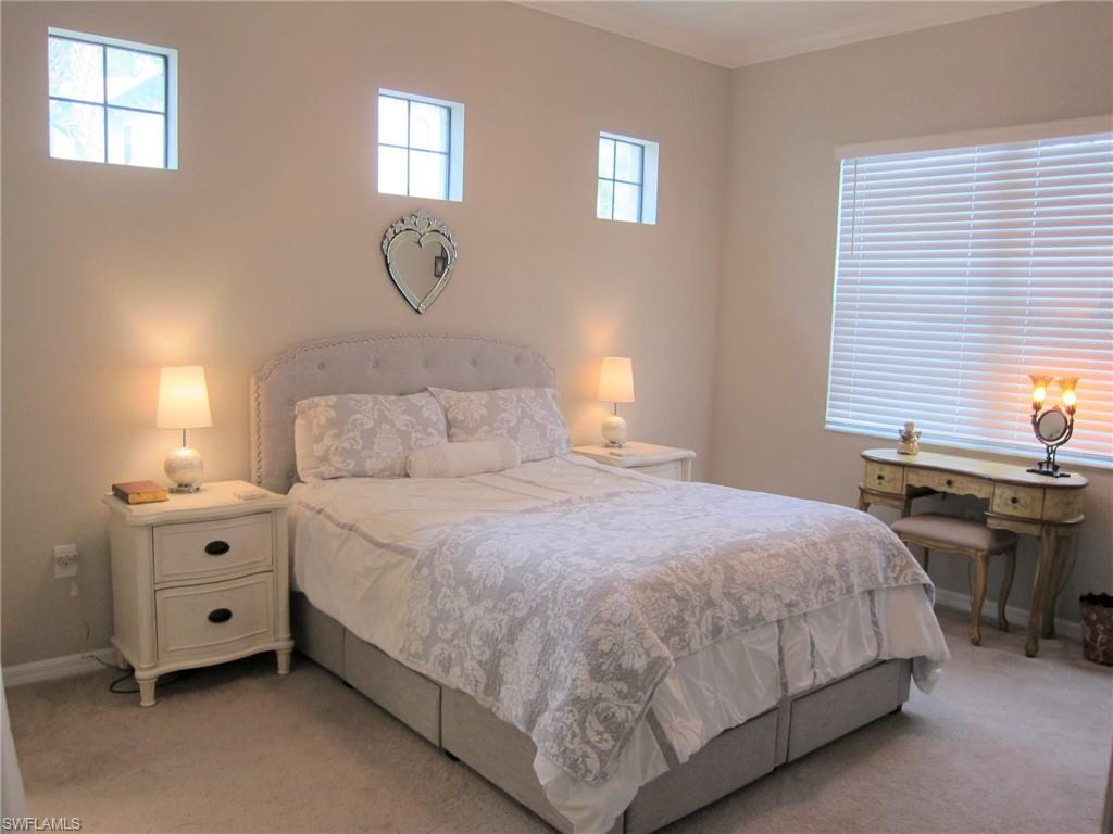1170 Genovesa Court, Unit 12 Naples, FL 34113 - Photo 7 of 18 a bedroom with bed and window