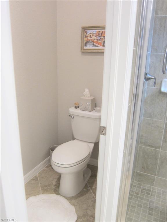 1170 Genovesa Court, Unit 12 Naples, FL 34113 - Photo 9 of 18 a white toilet sitting next to a shower