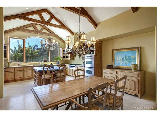 3520 Fortuna Ranch Road Encinitas, CA 92024 - Photo 3 of 11 Vaulted Ceiling With Hand Hewed Trusses, Low Voltage Recessed Task And Art Lighting, Two Matching Chandoliers, Custom Solid Wood Cabinets and Desk, Rare Sodilite Blue Granite Island, Chef's Kitchen With All Stainless Steel Appliances