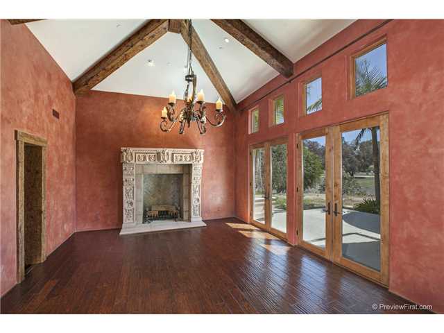 3520 Fortuna Ranch Road Encinitas, CA 92024 - Photo 4 of 11 Vaulted Ceiling With Massive Hand Hewed Beams, Low Voltage Task and Art Lighting, Custom Chandelier, Hand Carved Stone Rumford Fireplace, 2 Sets Of Single Light French Doors that Open To Front Entry, Recessed Speakers.