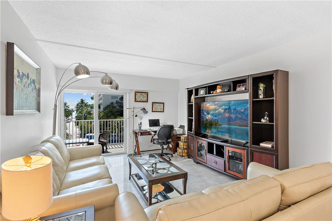 95 North Birch Road, Unit 405 Fort Lauderdale, FL 33304 - Photo 16 of 34 a living room with furniture and a flat screen tv