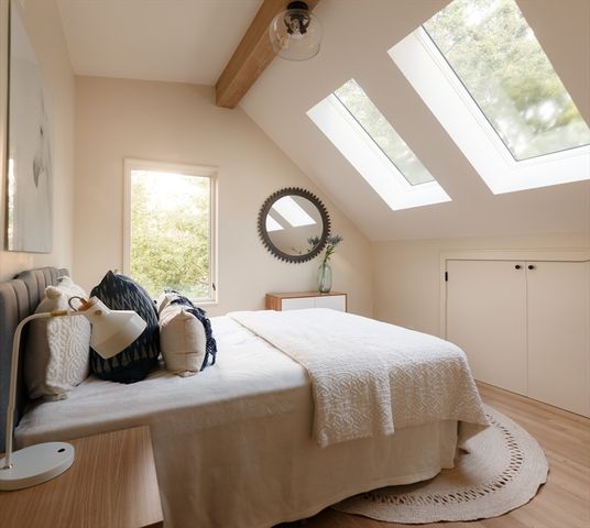 a bedroom with a bed and window