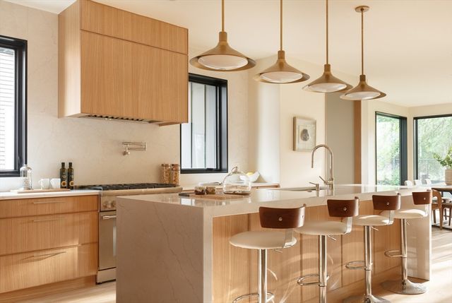 a kitchen with a sink cabinets and window